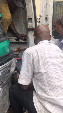 Vehicle repairs and roadside work underway in Ikeja, Nigeria