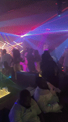 Nightclub gathering documented with laser lights and social activities