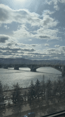 Morning sunlight illuminates river bridge in Krasnoyarsk