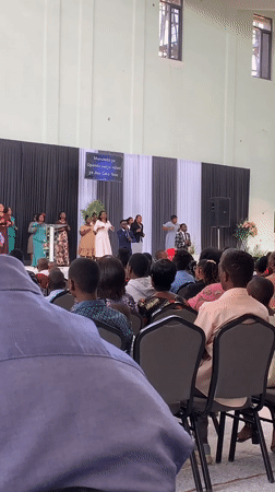 Choral performance at a large indoor gathering in Dodoma