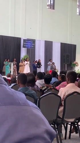 Choral performance at a large indoor gathering in Dodoma