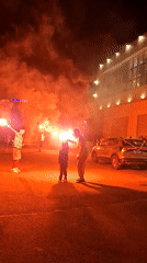 Flares, drums, and torches at a nighttime celebration in Sahline