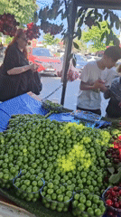 Fruit vendors serve customers at roadside stand in Kadıköy