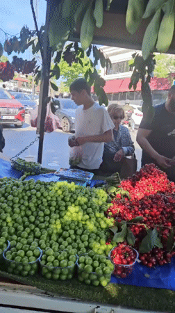 Fruit vendors serve customers at roadside stand in Kadıköy