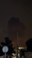 Large smoke plume rises over Tehran at night