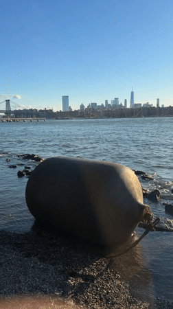 Large fender washed up on a rocky New York shoreline