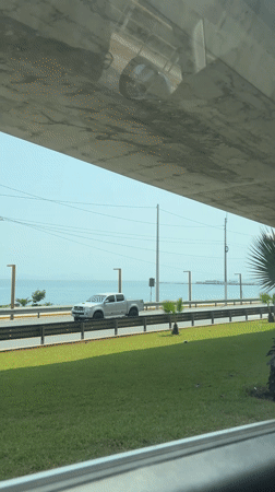 Vehicle travels scenic coastal road in Barranco, Peru