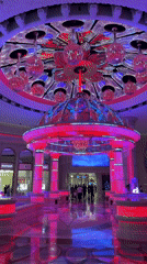 Ornate Macao interior space with fountain, peacock sculptures documented