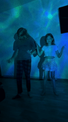 Indoor dance session under colorful projected lights in Chaikovsky