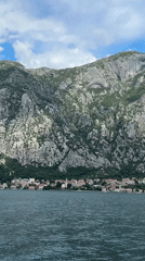 Boat passenger films Montenegro coastal town with distinctive church spire