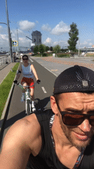 Cyclists rolling along a sunny Saint Petersburg bike path
