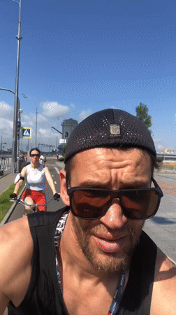 Cyclists rolling along a sunny Saint Petersburg bike path