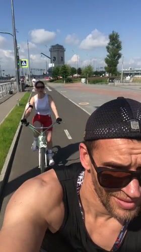 Cyclists rolling along a sunny Saint Petersburg bike path