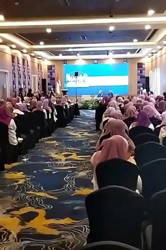 Indoor seminar and hotel pool scene in Denpasar
