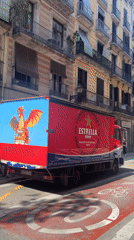 Estrella Damm delivery truck parked on sunny Barcelona street