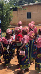 Women in pink perform circle dance in Nigerian village