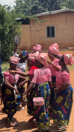 Women in pink perform circle dance in Nigerian village