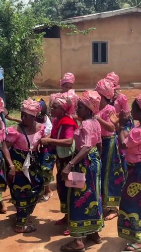 Women in pink perform circle dance in Nigerian village