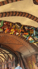 Suspended shoe art installation spotted under Berlin archway