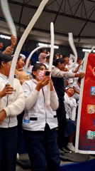 Students gather with inflatable objects in Arequipa school gymnasium