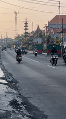 Rush hour traffic flows through East Java villages at dusk