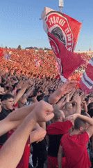Packed Sofia stadium, rival fan sections loud and flags flying