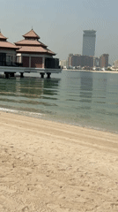 Morning beach stop in Dubai with shells, selfies, and stilted villas