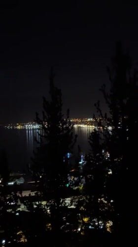 Nighttime cityscape captured in Fethiye, Turkey with water reflections