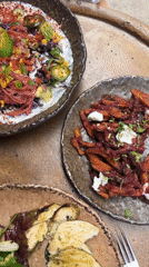 Three-dish meal documented on rustic table in Barcelona