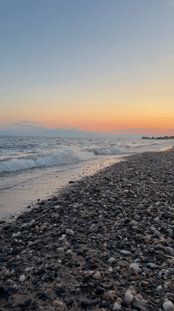 Sunset on a quiet pebble beach in Nea Flogita, Greece
