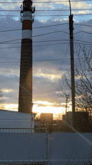 Young person documents daytime moon, industrial scenes in Chernushka