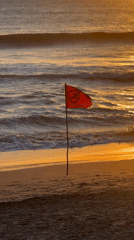Swimming banned flag waves on North Kuta beach
