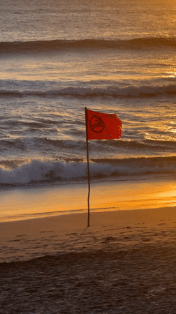 Swimming banned flag waves on North Kuta beach
