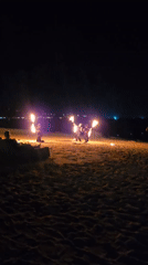 Fire performers light up a Ko Samui beach at night