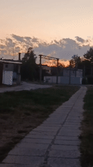 Dusk settles over a quiet walkway in Svietlahorsk, Belarus