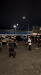 Group dances and runs near Arica port at night