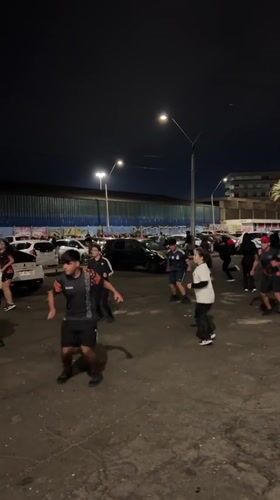 Group dances and runs near Arica port at night