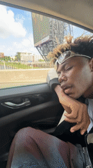 Passenger rests during drive past Ikoyi construction site