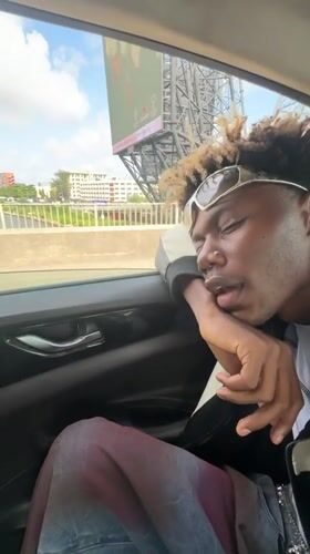 Passenger rests during drive past Ikoyi construction site