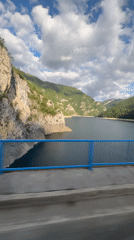 Bridge view captures serene mountain lake in Montenegro