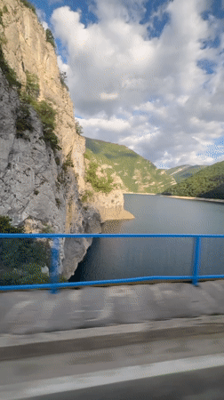 Bridge view captures serene mountain lake in Montenegro
