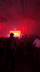 Music event with stage displays draws dancing crowd