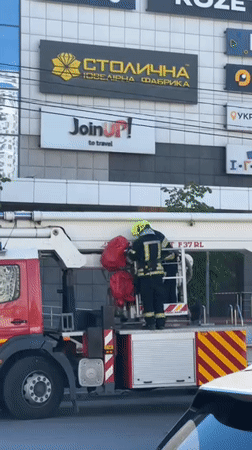 Emergency crews respond to damaged apartment building in Kyiv