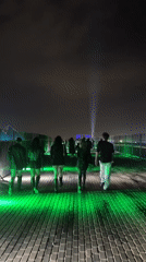 Nighttime gathering draws crowds to illuminated structures in Giza