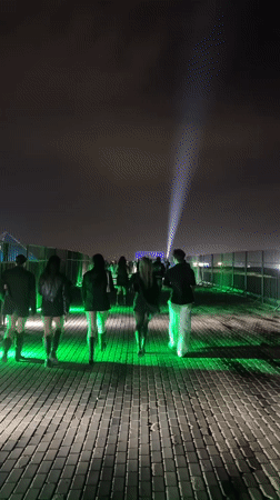 Nighttime gathering draws crowds to illuminated structures in Giza