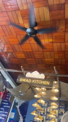Restaurant interior with spinning ceiling fan documented in Hanoi