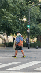 Person crosses Buenos Aires street intersection wearing distinctive yellow shoes