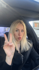 Woman photographed driving, taking selfies across city locations