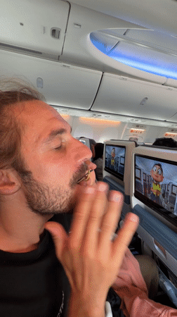 Passenger eats with eyes closed aboard aircraft near Kathmandu