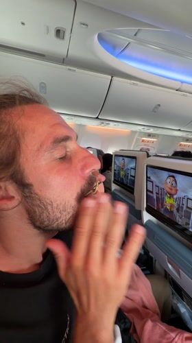 Passenger eats with eyes closed aboard aircraft near Kathmandu